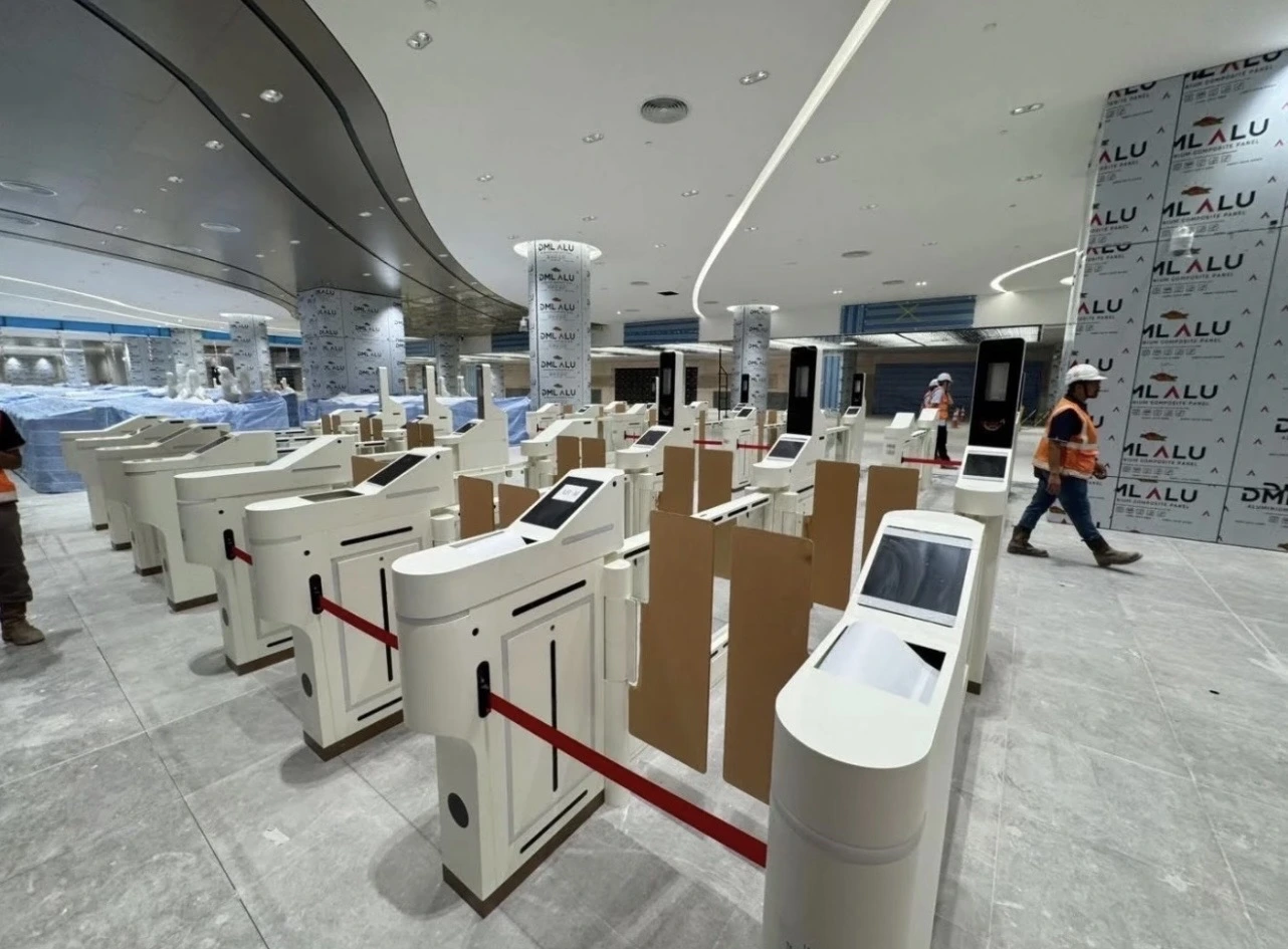 Station interior with ticket gates and construction activity